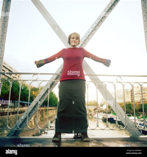 Woman Standing On Bridge With Arms Stretched Out Stock Photo Alamy