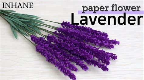 Some Purple Flowers Sitting On Top Of A Wooden Table With The Words Paper Flower Lavender