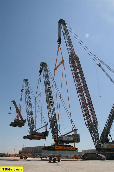 A crane being hoisted by another crane, being hoisted by a 3rd crane ...