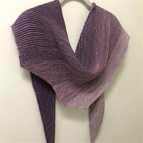 A Purple Scarf Hanging On A White Wall