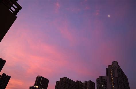 Premium Photo | Fantastic sunset sky over the city with a bright quarter moon