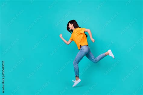 Full Length Photo Of Cute Brunette Lady Run Wear Orange T Shirt Jeans