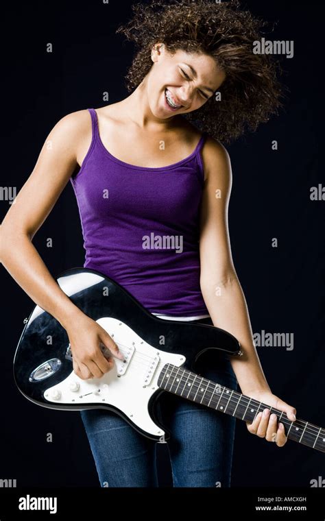 Girl playing electric guitar Stock Photo - Alamy