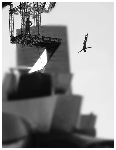 A Black And White Photo Of A Person Doing Tricks On A Skateboard In The Air