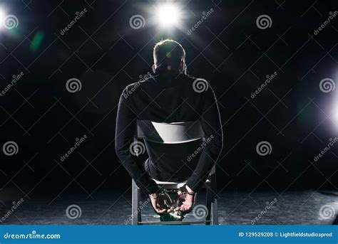 Rear View Of Man In Handcuffs Sitting Stock Photo Image Of Rear