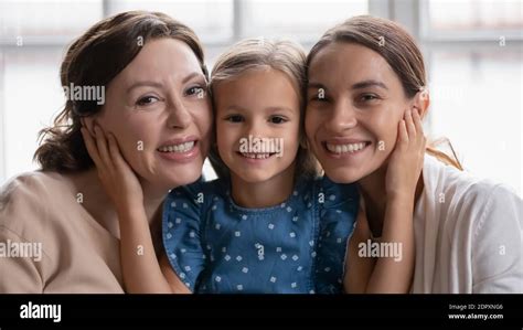 Head Shot Portrait Smiling Three Generations Of Women Posing Together