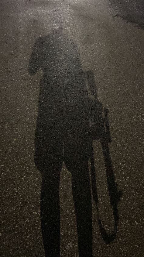 The Shadow Of A Person Holding An Umbrella