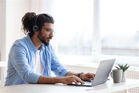 Handsome Western Freelancer Guy Working Remotely With Laptop At Home