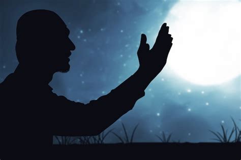Premium Photo | Man standing while raised hands and praying