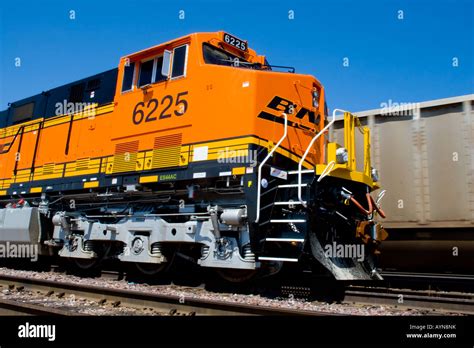 A brand new BNSF locomotive sits in the yard in Chicago as a coal train ...