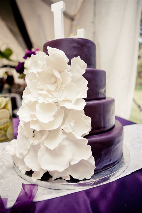 Purple And White Wedding Cake With Beautiful Flower Decorations