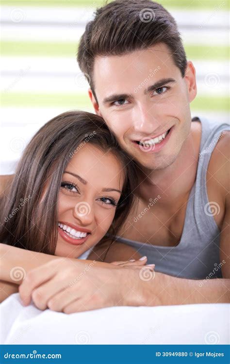 Happy Couple Hugging In Bed Stock Photo - Image: 30949880