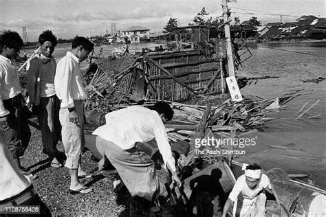 People stand at a flooded area a day after Typhoon Vera, aka Isewan... News Photo - Getty Images