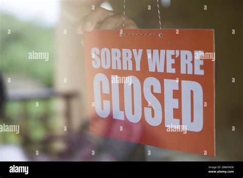 Closed Sign Board Hanging On The Glass Door Of Cafe Or Small Store