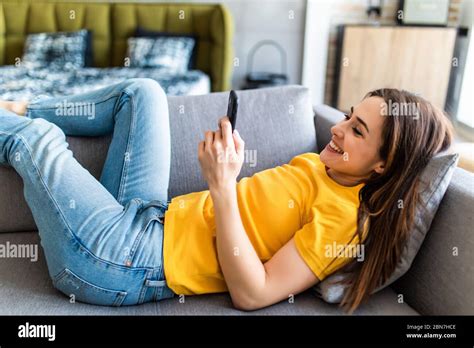 Attractive Woman Smiling As She Reads An Sms Message On Her Mobile