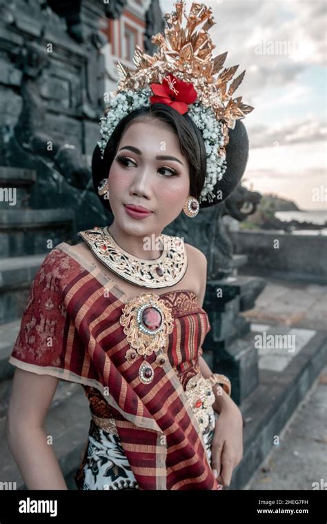 Portrait Bali Girl With A Traditional Dress Standing With Folding Fan