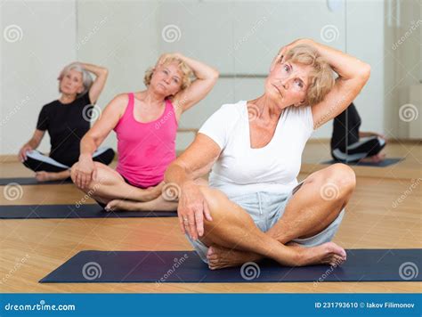 Group Of Mature Women Exercising In Lotus Pose Stock Photo Image Of