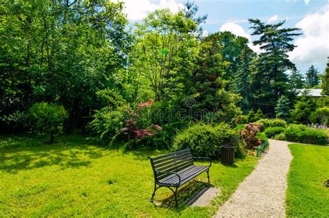 Photo About A Sunny Day In The Park A Bank And Lots Of Greenery Image