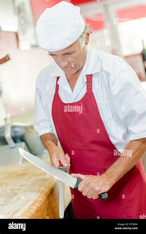 Butcher sharpening knife Stock Photo - Alamy