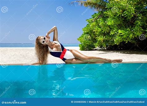 Woman In Bikini Near The Pool At Maldives Tropical Island Elegant