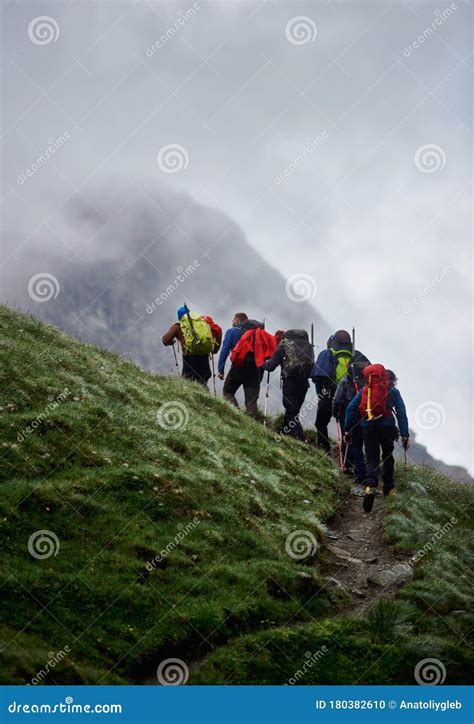 Group Of People Walking Uphill In Mountains Stock Photo Image Of