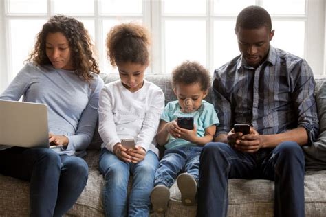 African American Family with Kids Using Devices at Home Stock Photo ...