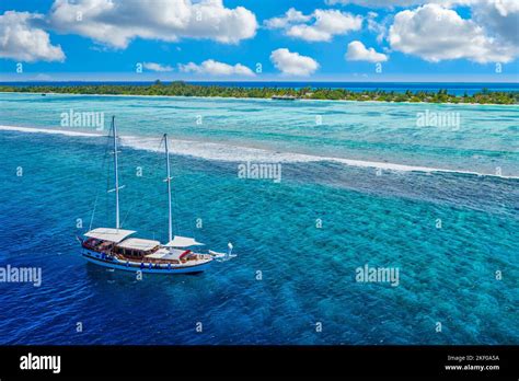 Small Yacht Sailing In Tropical Sea Over Coral Reef In Indian Ocean