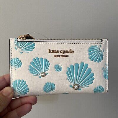 NWT Kate Spade Morgan Seashell Printed Slim Bifold Leather Wallet Cream