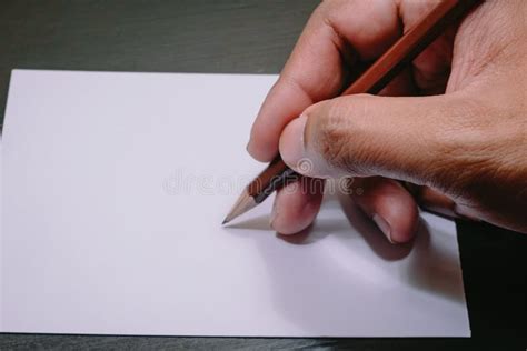 Humans Hand Holding Pencil To Write On The Paper Stock Image Image