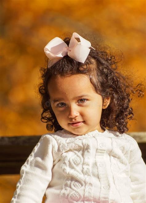 Portrait Of Cute Girl Sitting On The Ground Stock Photo Image Of