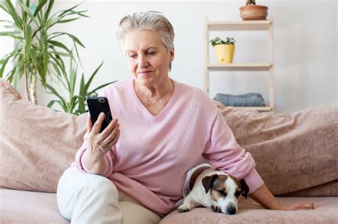 Relaxed Mature Old 60s Woman With Phone At Home Stock Image Image Of