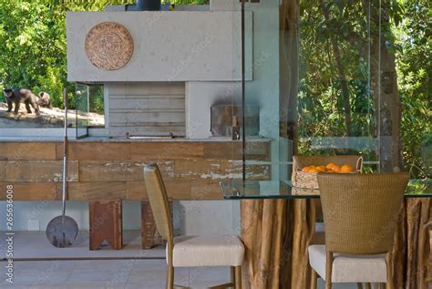 Dining Table In Nude Tone With Barbecue In The Background Integrated