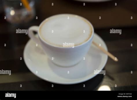 Cup Of Hot Frothy Latte Coffee With Bokeh Light Blur Background Stock