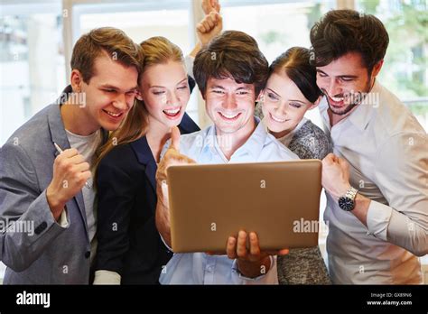 Start Up Team With Laptop Celebrating Their Success Stock Photo Alamy