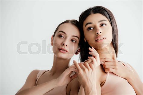 Young Multicultural Girls In Beige Outfit Tenderly Touching Each Other