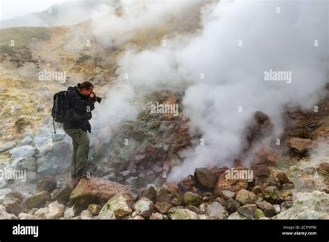 Male Photographer Takes Pictures Of Aggressive Volcanic Landscape Hot Spring Eruption Fumarole