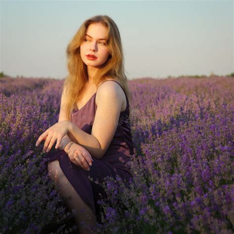 Beautiful Blonde Girl With Long Hair On A Lavender Field In The Evening Stock Photo Image Of