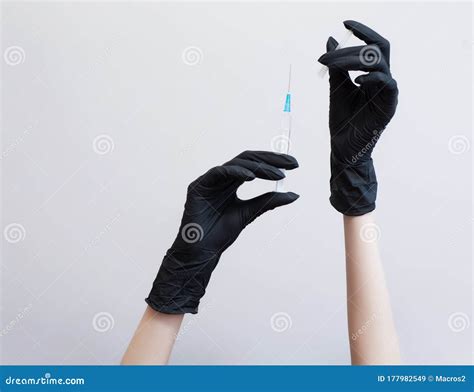 Hands In Protective Gloves With A Syringe And Antiseptics Stock Image