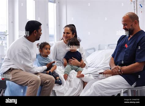 Parents With Children In Hospital Room Stock Photo Alamy