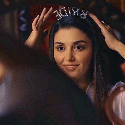 A Woman Wearing A Tiara And Smiling At The Camera With Her Hands On Her