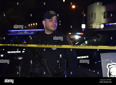 Police Officer From Newark Police Secures The Crime Scene With A Long