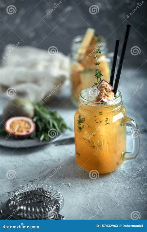 Tropical Cocktail With Passion Fruit Lime And Mint On A Gray