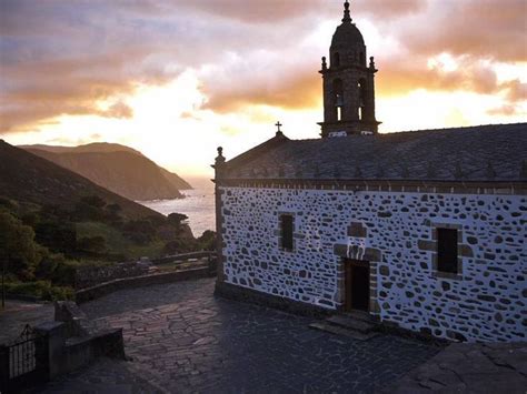 The Sun Is Setting Over An Old Church