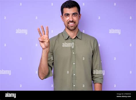 Cheerful Brunette Bearded Man Demonstrating The Letter W W Sign
