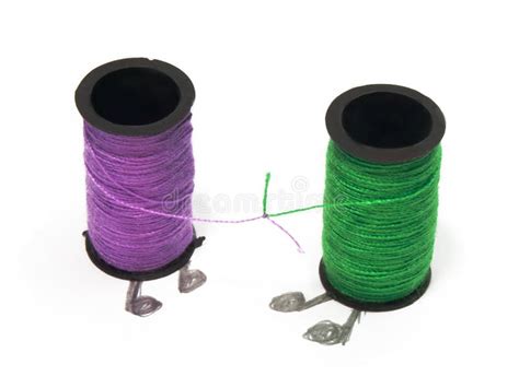 Two Spools With Threads With Their Endings Tied Together Stock Image