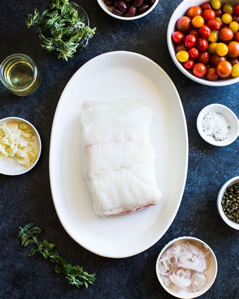 Baked Halibut With White Wine Olives Capers And Tomatoes Heinen S