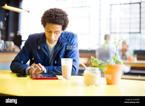 Man Using Digital Tablet In Cafe Stock Photo Alamy