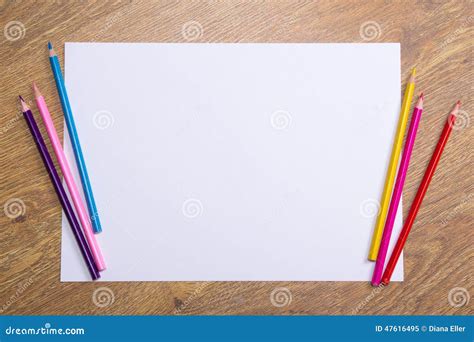 Colorful Drawing Pencils And Blank Paper On Wooden Table Stock Image