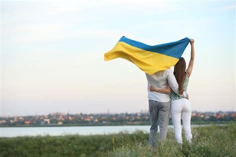 Premium Photo Friends Holding National Flag Of Ukraine In Field Back