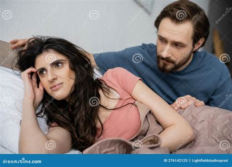 Blurred Man Looking At Brunette Girlfriend Stock Image Image Of